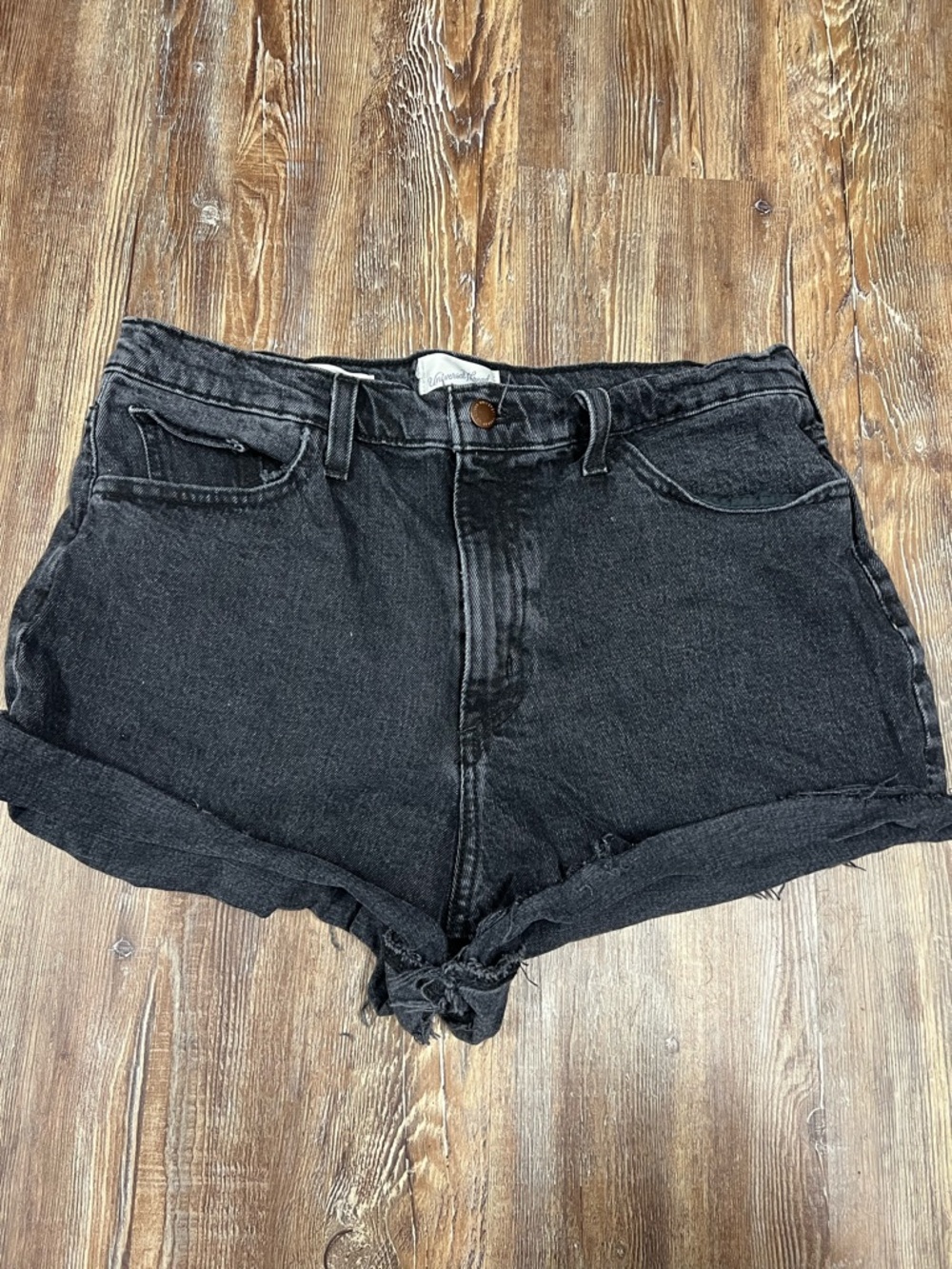 Black high-waisted denim shorts with frayed hem